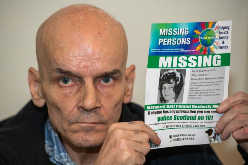 Archie Moody with a flyer looking for his mum Margaret, missing since 1977. Image: Kami Thomson/DCT