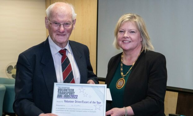Ken Fairweather receiving his volunteer of the year award  from Provost of Aberdeenshire Judy Whyte. Image:  Mearns & Coastal Healthy Living Network.