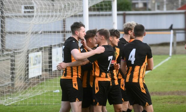 Huntly's players celebrate their first goal against Turriff which was scored by Kyle Dalling, left