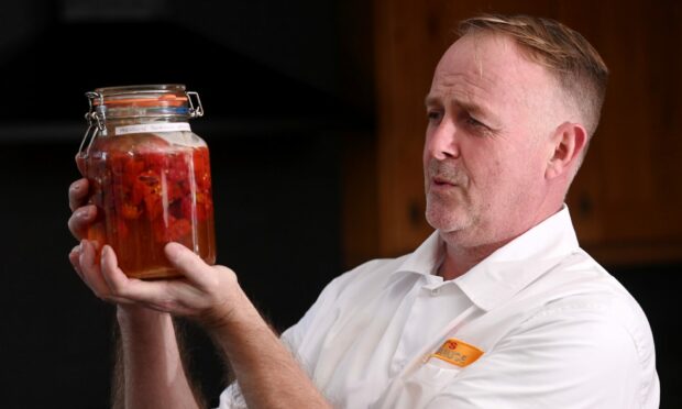 Jim McWilliam samples chillies from all over the world to help concoct his fiery sauces. Image: Darrell Benns/DC Thomson