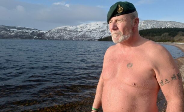 Tim Crossin in a very cold and snowy Loch Ness. Image: Sandy McCook/DC Thomson.