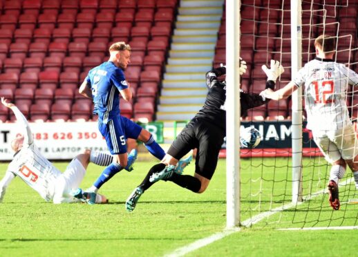 Jason Brown scores for Peterhead against Dunfermline. Image: Duncan Brown