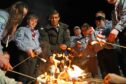 Prime Minister Rishi Sunak toasts marshmallows during a visit to the Sea scouts community group in Muirtown near Inverness