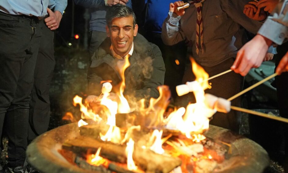 Prime minister Rishi Sunak toasts marshmallows with Sea Scouts