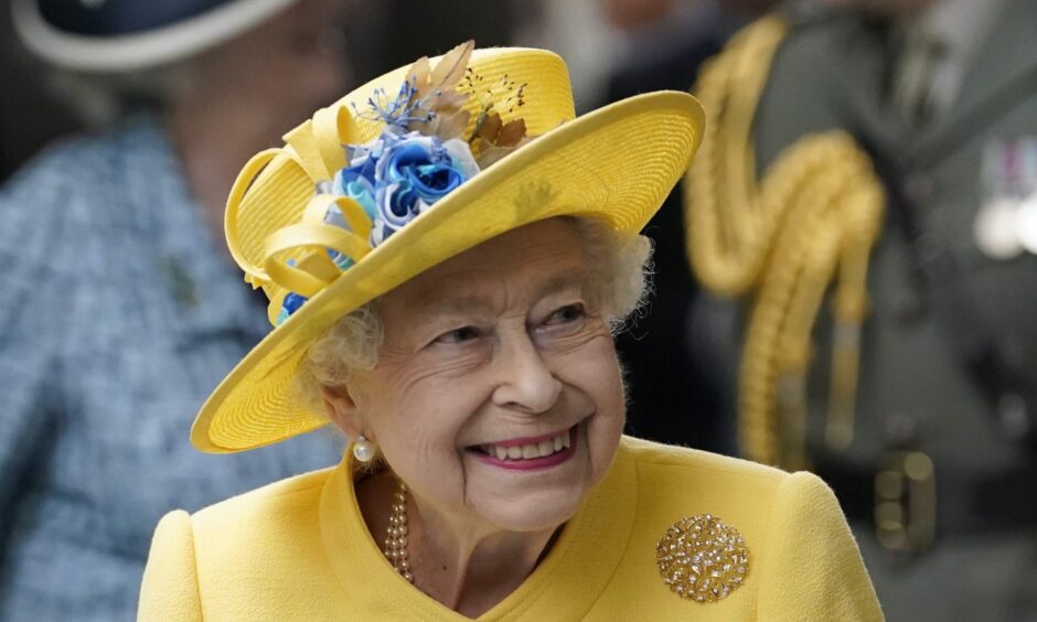 Queen Elizabeth II in yellow outfit and hat