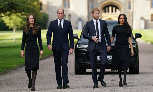 The Prince of Wales and the Duke and Duchess of Sussex walking to meet members of the public at Windsor Castle in Berkshire following the death of Queen Elizabeth II. Image: Kirsty O'Connor/ PA Wire