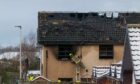 Fire crews remain on the scene inspecting the fire-damaged building. Image: Jasperimage