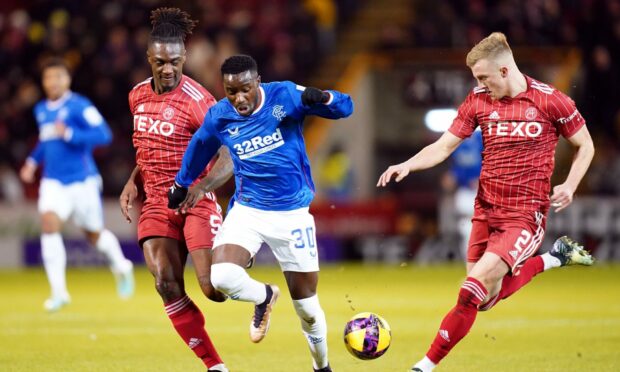Rangers' Fashion Sakala battles for the ball with Aberdeen's Ross McCrorie (right) and Anthony Stewart (left) at Pittodrie. Image: PA