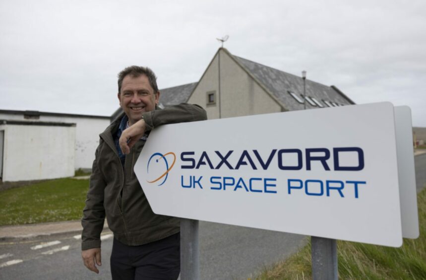 SaxaVord Spaceport deputy CEO Scott Hammond leaning on SaxaVord Spaceport sign