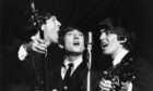 Paul McCartney, John Lennon and George Harrison on stage in 1963 after The Beatles became superstars. Image: Shutterstock.