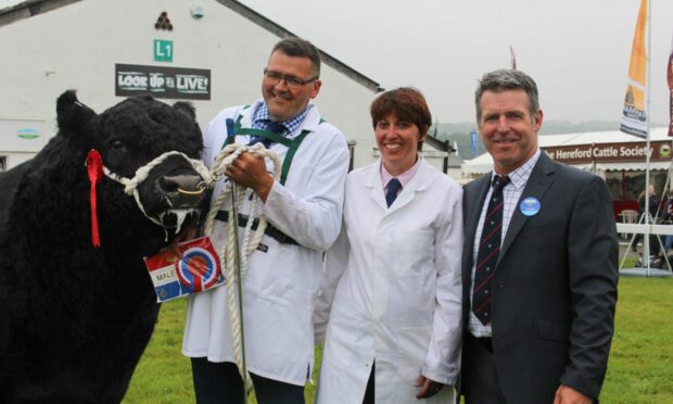 Jason and Sarah Wareham pictured with the judge and their Great Yorkshire Show champion in 2019.
