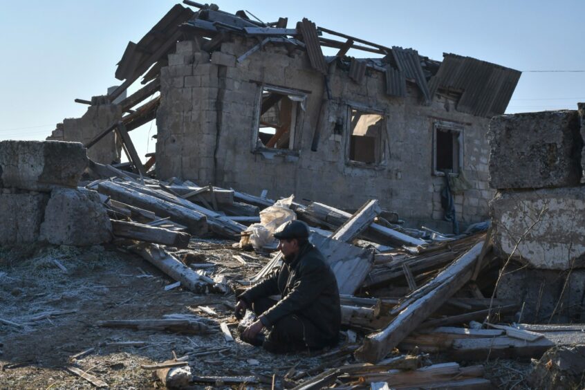 Local resident sits near ruins of his house after a Russian night rocket attack in Zaporizhzhya, Ukraine.