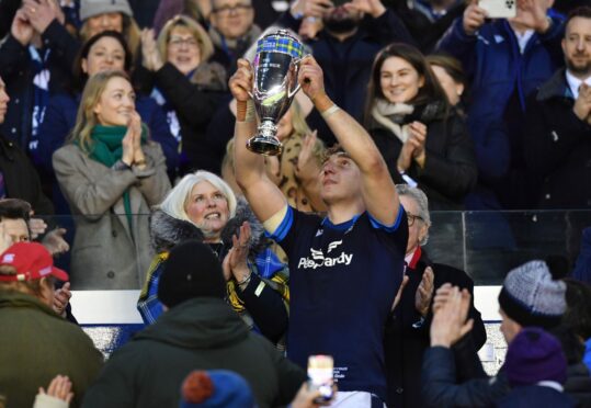 Jamie Ritchie accepts the Doddie Weir Cup from Kathy Weir after Scotland's win.