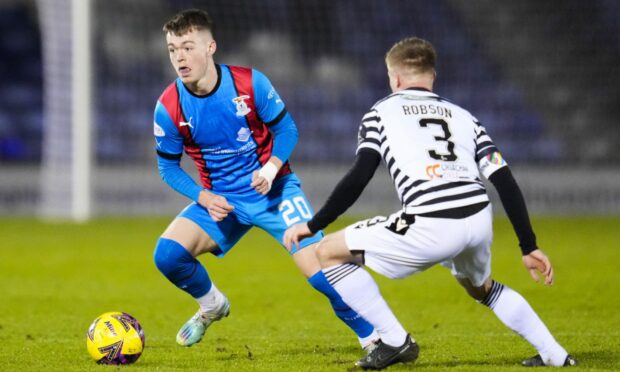 Jay Henderson takes on Queen's Park's Tommy Robson. Images: SNS Group