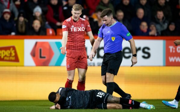 Aberdeen's Ross McCrorie after his coming together with St Mirren's Charles Dunne. Image: SNS