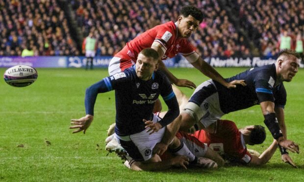 Finn Russell's brilliant offload sparked Scotland to their record win against Wales. Image: SNS