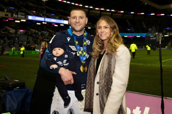 Finn Russell with girlfriend Emma Canning and daughter Charlie after the game.