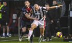 Ross County's Keith Watson gets to grips with St Mirren's Curtis Main. Images: Rob Casey/SNS Group