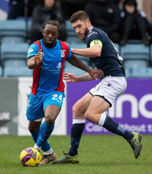Caley Thistle striker Austin Samuels tries to get past Dundee's Ryan Sweeney. Image: SNS