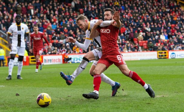 Nicky Devlin, left, and Dons skipper Graeme Shinnie in action. Image: SNS