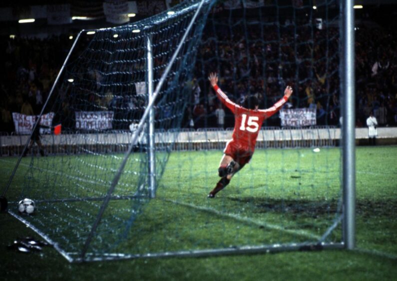 John Hewitt turns away in delight after scoring the Dons winner against Real Madrid. Image: SNS.
