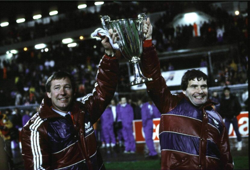 Aberdeen assistant manager Archie Knox (right) and manager Alex Ferguson hold up the European Cup Winners Cup after beating Real Madrid in the final. Image: SNS