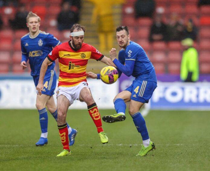Cove's Connor Scully battles for the ball with Partick Thistle's Stuart Bannigan. Image: Dave Cowe
