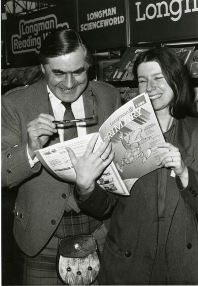 1988 - Grampian Region’s director of education James Michie gets a better look at a book in a display of educational equipment, with a helping hand from Jane Frith, of Longman, Oliver and Boyd.