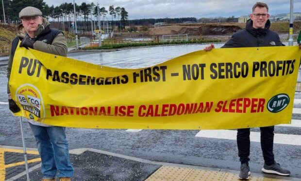 RMT activist George Alexander MacIver,, left, with branch secretary,  Conor Cheyne, with their bright yellow banner calling for Caledonian Sleeper to be taken into public ownership. Image: RMT