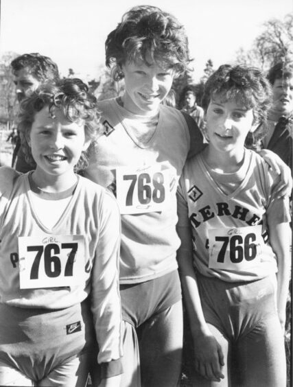 Three young girl runners after competing in cross country running north-east