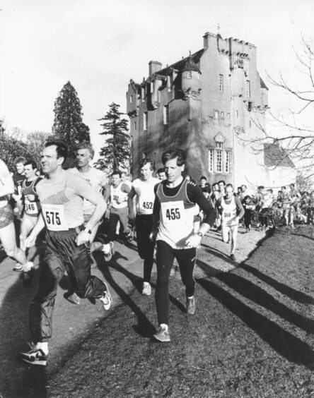 Men running with a castle in the background