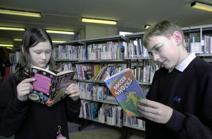 A girl and boy reading their books