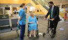 Health Secretary Humza Yousaf speaks to long covid patient Pamela Bell at the announcement of a £10 million support fund. Image: PA