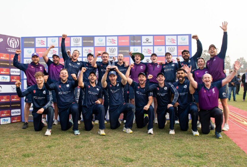 Scotland players celebrate with the WCL2 trophy. Image: Ian Jacobs/Cricket Scotland