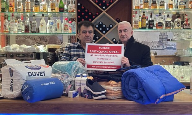 Mustafa Calisir, pictured left, and Ismail Dogan with items generously donated by people for those struggling in Turkey. Image: Ross Hempseed/DC Thomson.