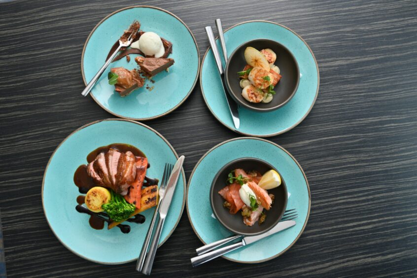 Four dishes from The Sun Dancer, all on matching picture-perfect blue plates