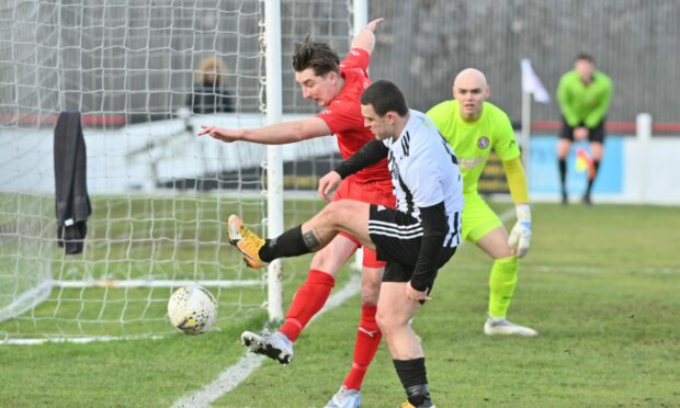 Brora Rangers defender Colin Williamson, left, is pressured by Fraserburgh's Scott Barbour