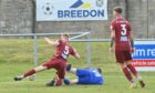 Lossiemouth's Ross Morrison, centre, is grounded by the challenge from Lewis Coull of Keith, left