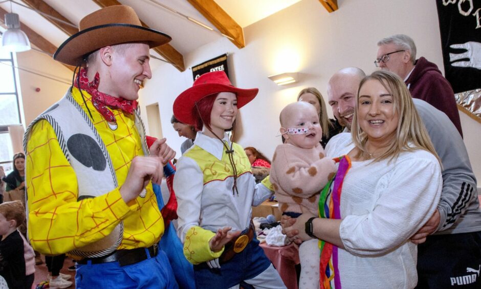 Actors dressed as Toy Story characters with Molly Burnett and her parents, Lewis Burnett and Nadia Hopkins