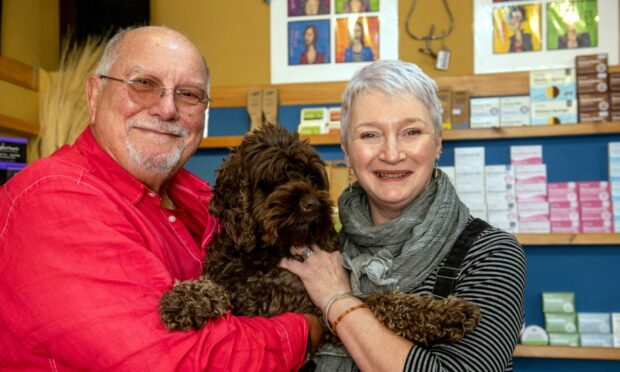 Quirky is one word to describe How Bizarre How Bizarre, a new shop in Stonehaven offering all things weird and wonderful. Pictured are owners David Neill and Adele Mackie with their adorable therapet Rudi. Image: Kath Flannery/DC Thomson.
