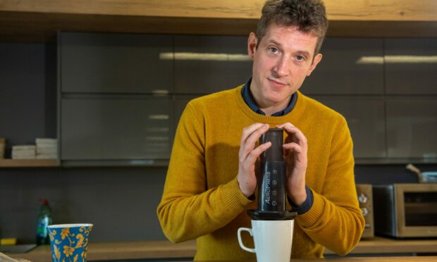 Can coffee lover Andy Morton squeeze in a few extra cups before hitting his daily limit? That depends where he gets his coffee from. Image: Kami Thomson/DC Thomson