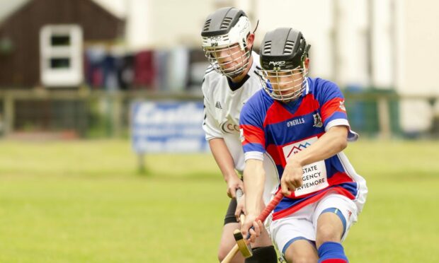 Kingussie's Eoin Baikie, right, in action against Lovat. Image: Neil Paterson