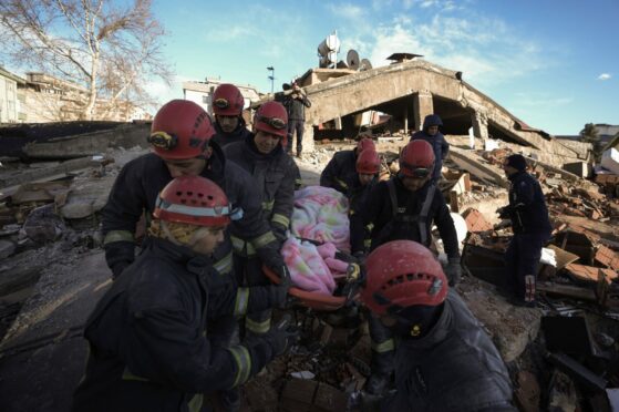 Firefighters from the north-east will join rescue teams already working to find survivors of the devastating quake. Today rescue teams evacuated a survivor from the rubble of a destroyed building in Kahramanmaras, southern Turkey. Image:  AP/Khalil Hamra