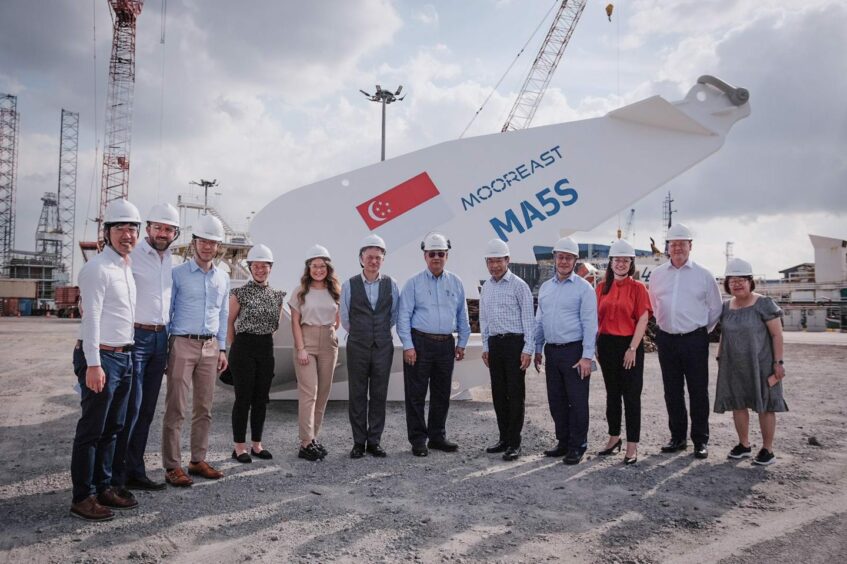 Scottish trade minister Ivan McKee and ETZ offshore renewables director Andy Rodden with Mooreast staff following the signing ceremony in Singapore