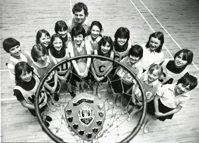 1981 - Members of the Fernielea and Woodside primary schools’ netball teams admire the new Evening Express Shield before the match, which launched the competition, at Fernielea.