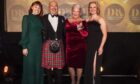 Alex and Ruth Grahame, centre, take to the stage to receive best newcomer from the hosts of the Drinks Retailing Awards last week. Image: Drinks Retailing News