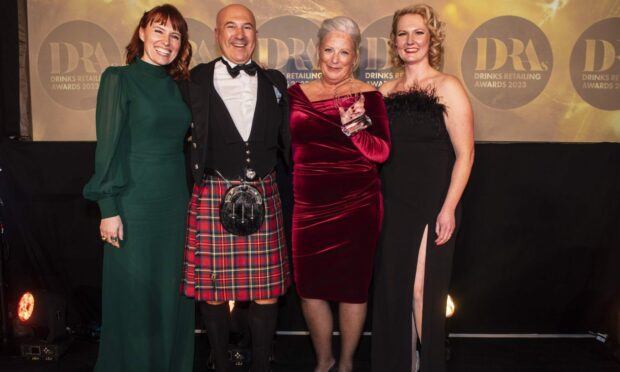 Alex and Ruth Grahame, centre, take to the stage to receive best newcomer from the hosts of the Drinks Retailing Awards last week. Image: Drinks Retailing News