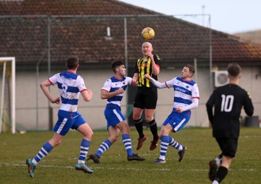 East End's Michael Keller wins this header against Dyce. Image:  Darrell Benns/DC Thomson
