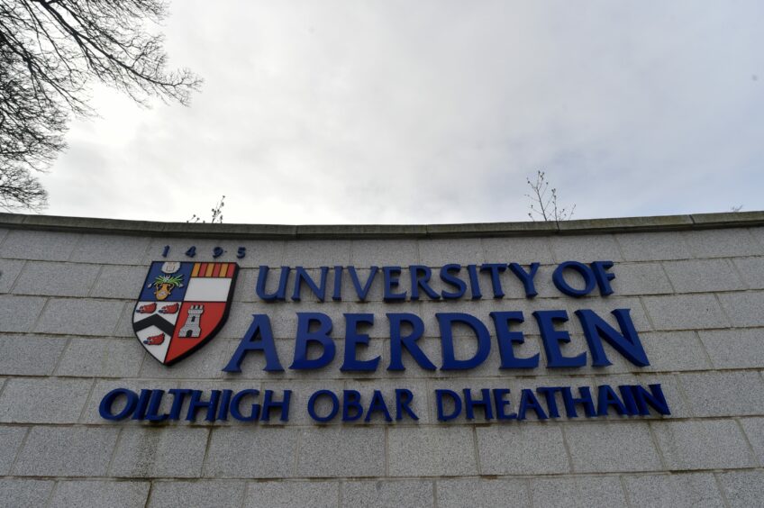 University of Aberdeen wall sign with Gaelic translation and university logo.