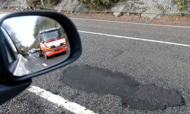 The crumbling A82 road with all its potholes between Inverness and Urquhart Castle.